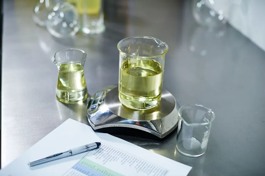 Beakers containing soybean oil on a laboratory scale.