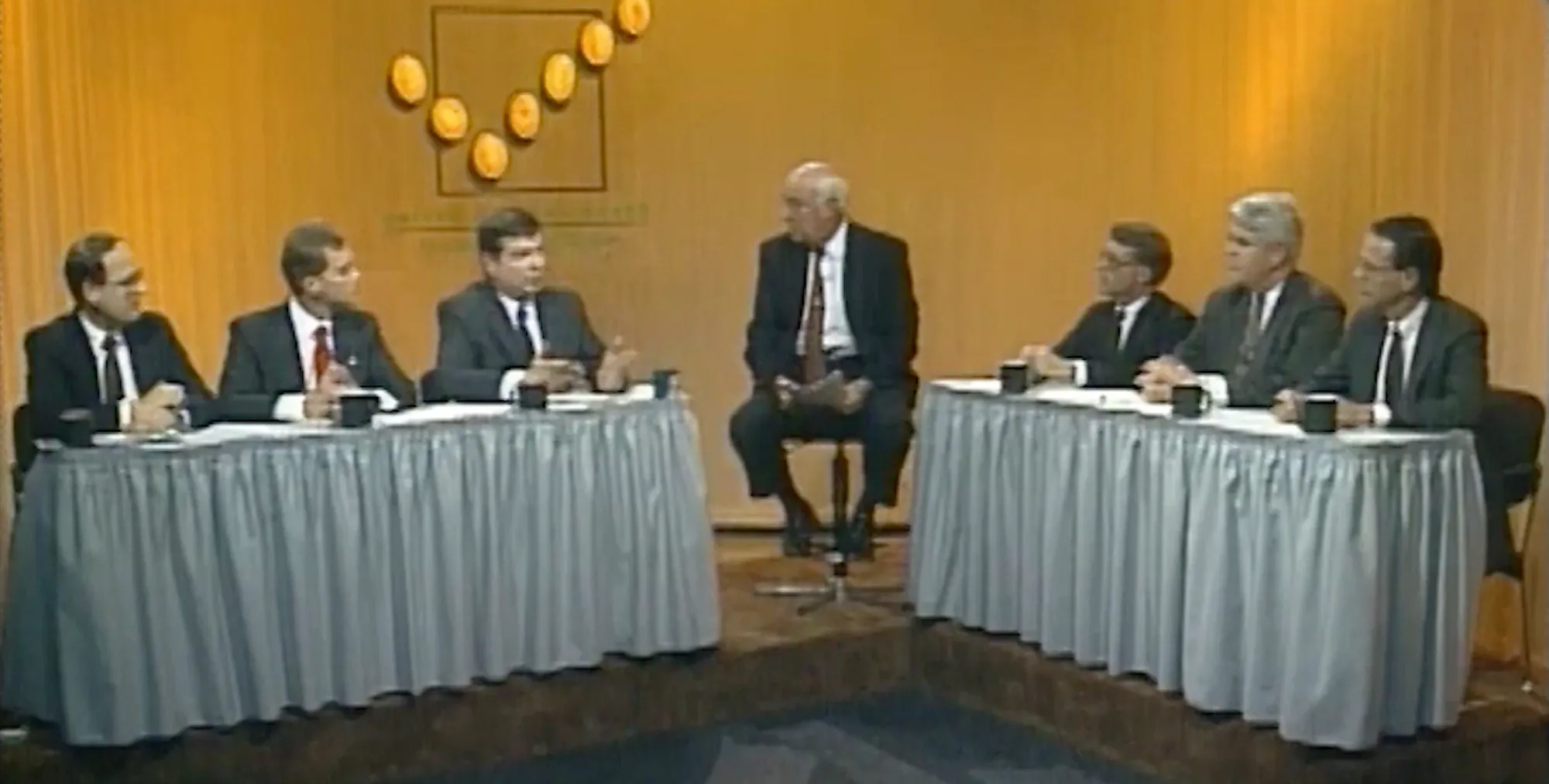 Panel discussion featuring several checkoff leaders seated at conference tables in a studio setting, engaged in conversation