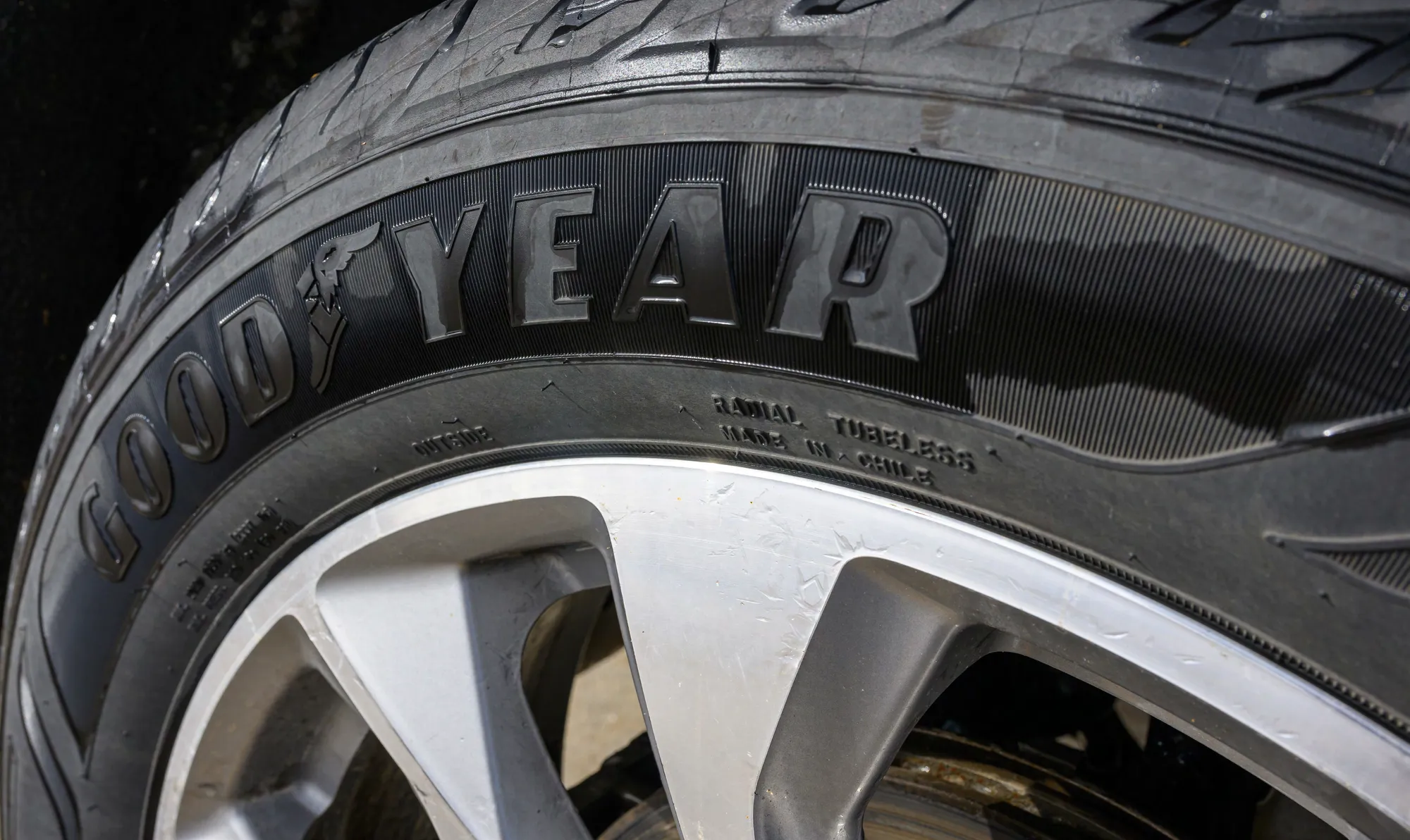 Close-up of a vehicle tire mounted on a wheel, with the Goodyear brand name prominently displayed on the sidewall.
