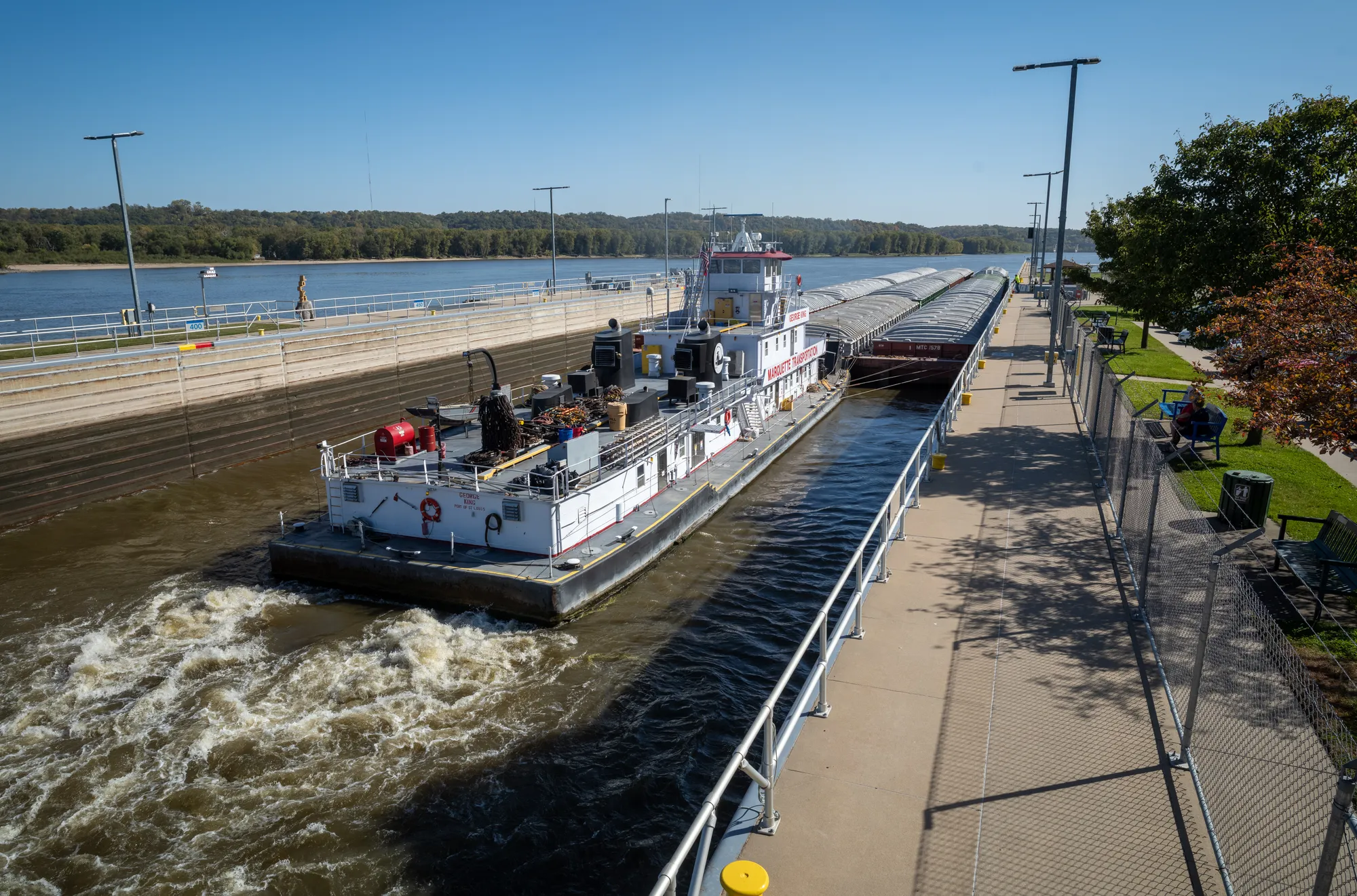 A large cargo ship traveling through a shipping canal.