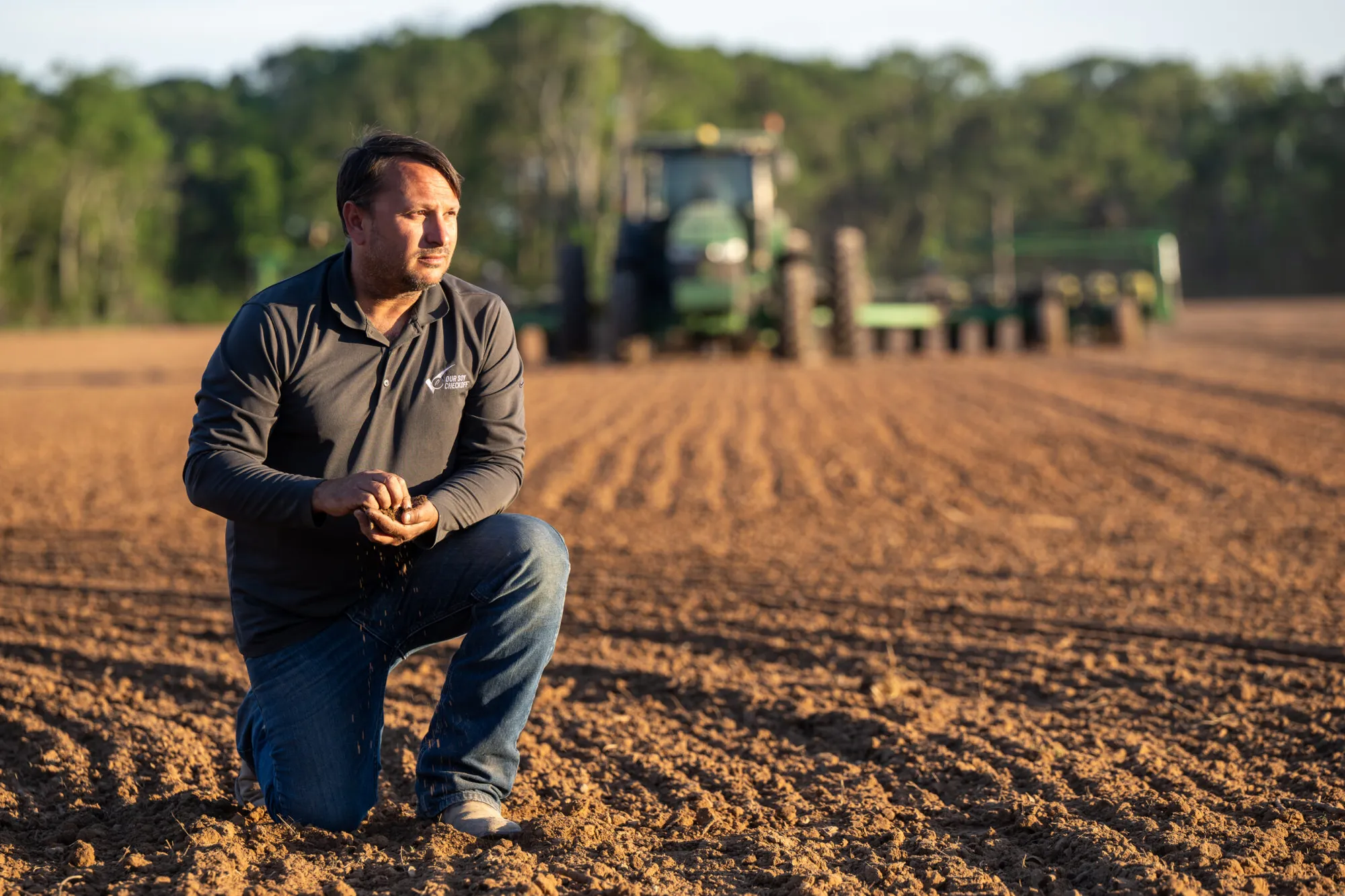 Joey Boudreaux holds soil during soybean planting.