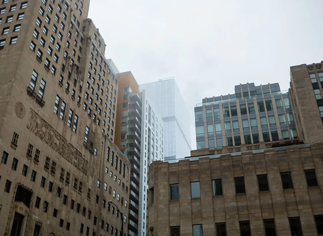 A cluster of tall city buildings in winter being heated with BioHeat.