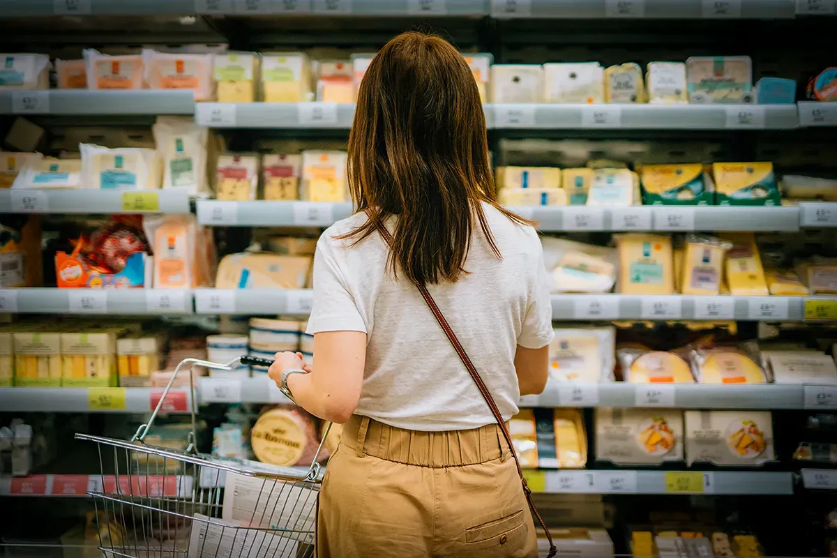 woman with back toward camera in shopping aisle