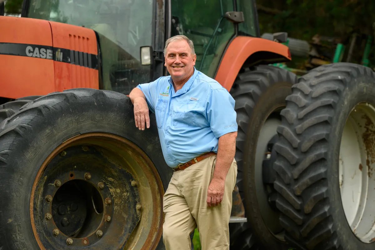 Fitzhugh Bethea III, a South Carolina soybean farmer and United Soybean Board director, stands beside a tractor on his farm in Dillon, South Carolina.