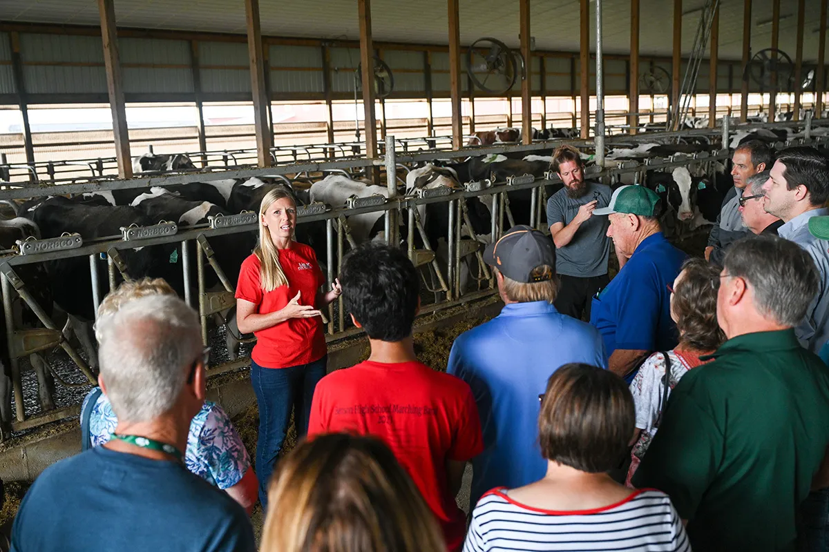 People touring a dairy barn at Oakfield Corners Dairy in New York.