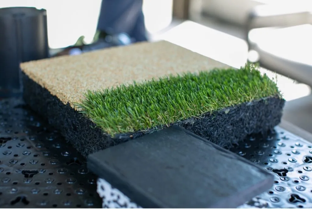 A close-up of SYNLawn’s bio-based artificial turf, showing layered construction made with soy-based and recycled materials.