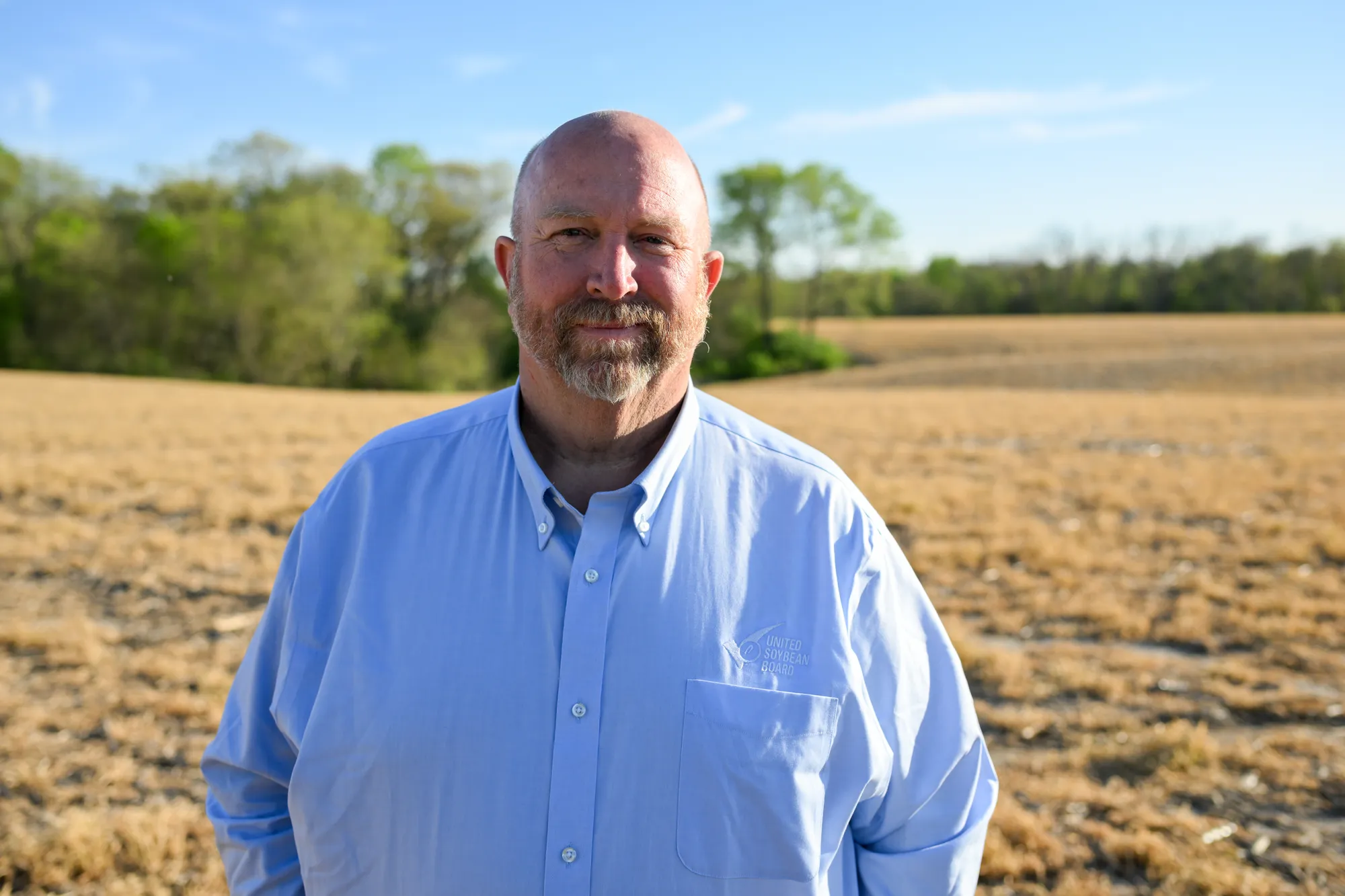 Farmer standing in a field.