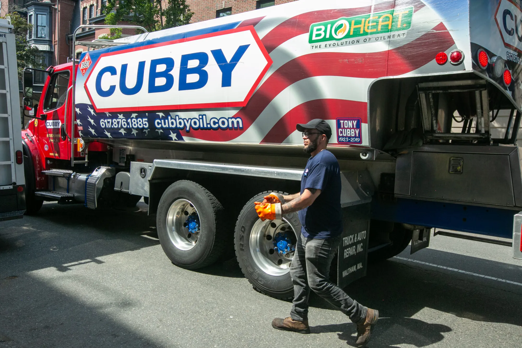 Worker walks beside a Cubby Oil truck promoting Bioheat.
