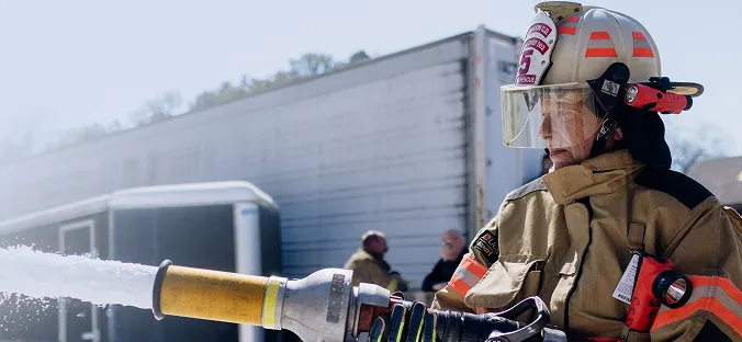 fire man handling firehose
