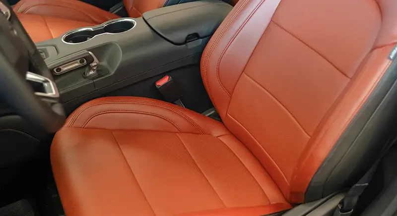 Car interior with upholstered seats, representing the use of soy-based adhesives that replace formaldehyde in furniture and flooring.