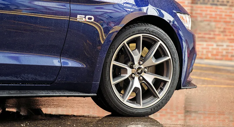 Car tires on a vehicle representing soybean oil's role in replacing petroleum in rubber compounds.