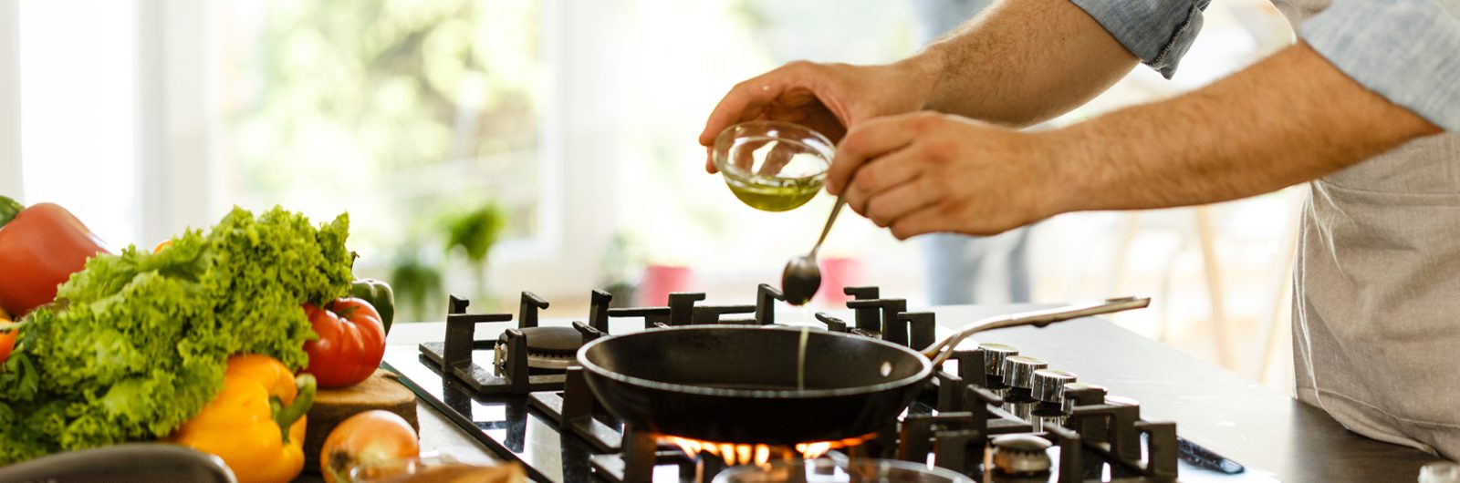 Oil being placed into a cooking pan